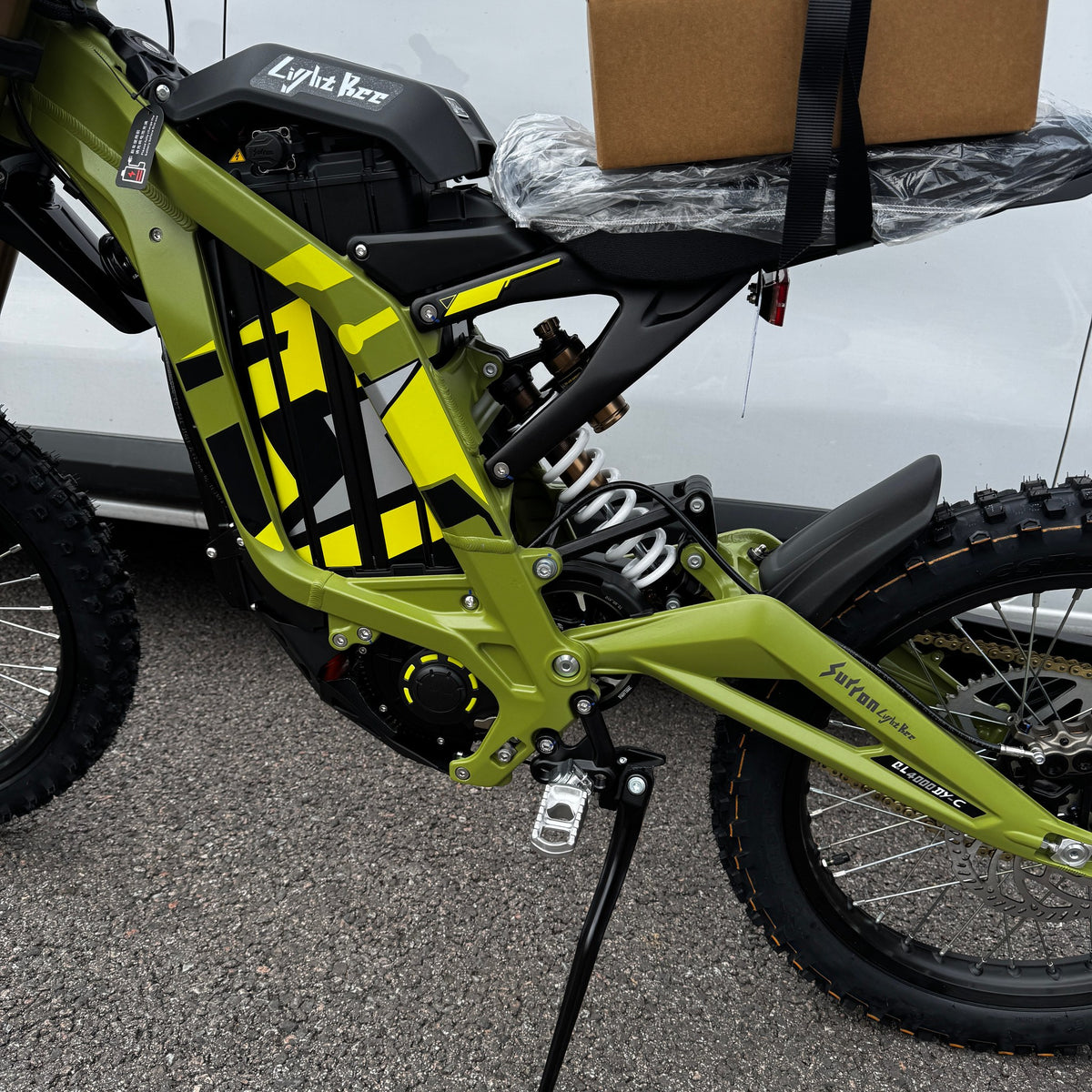 2026 Sur-Ron Light Bee X in Green, close-up of the frame graphics, motor and rear shock